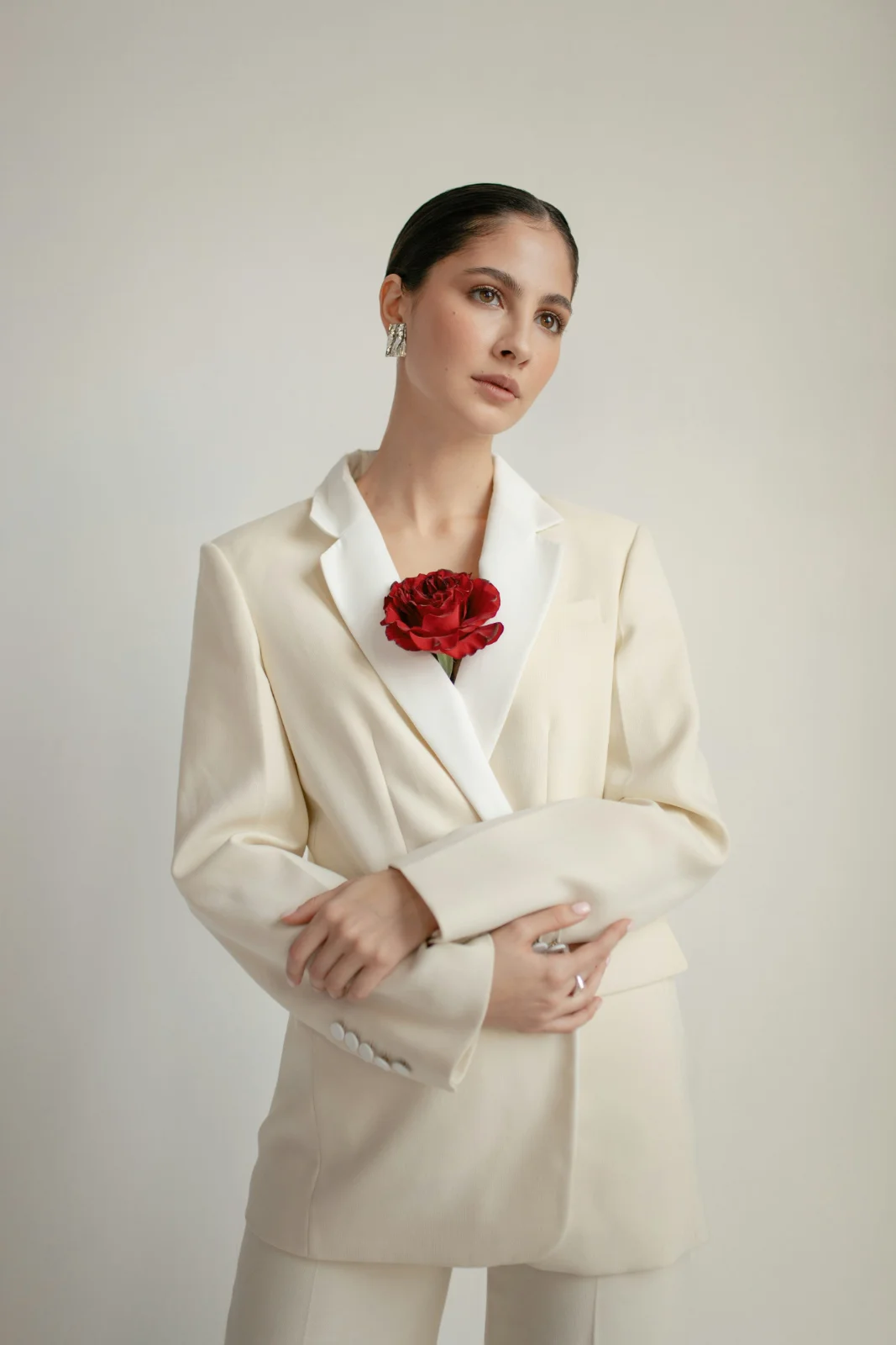 Woman in a white blazer standing for a full-body fashion portrait
