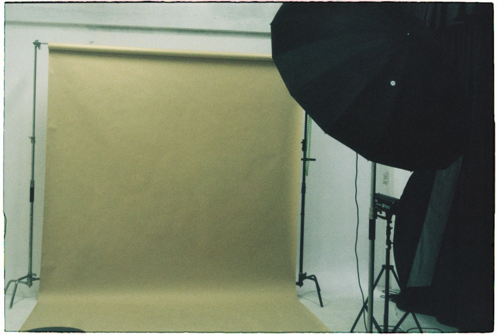 Empty photography studio with backdrop and lighting equipment set up for a portfolio photoshoot